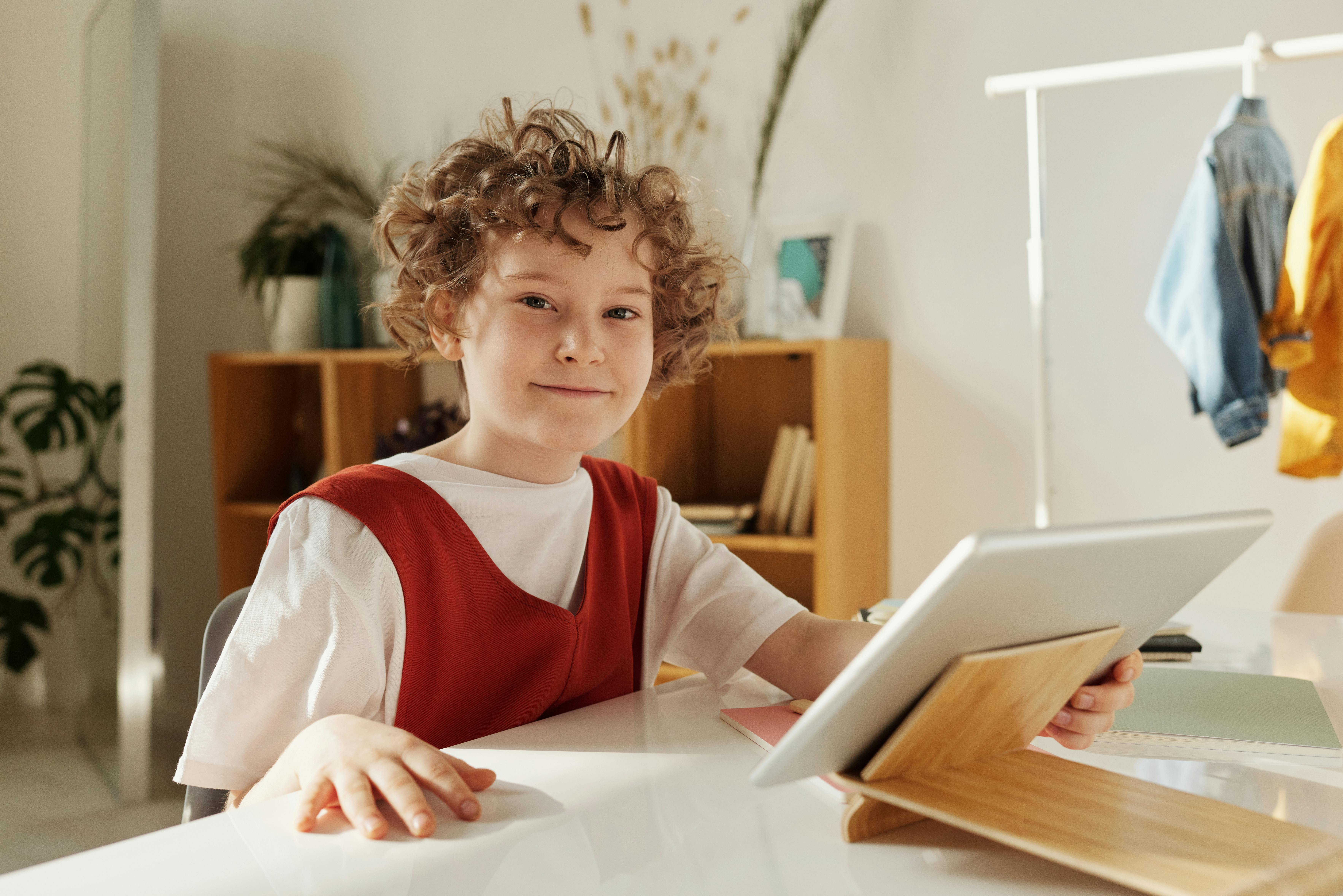K-12 student using a school-issued iPad on a protective stand, illustrating daily device usage in a classroom environment.